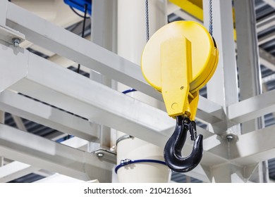 Crane hook inside factory building, industrial background. focus on the crane hook