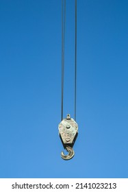 Crane hook on a blue sky. Crane hook. Crane hook on the background of a blue, cloudy sky. - Shutterstock ID 2141023213