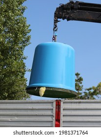 Crane And Large Recycling Bin And A Truck During Emptying