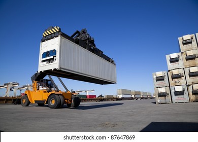 Crane Lifting Up Container In Railroad Yard