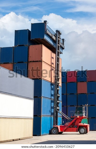 Crane
lifting up container in railroad yard. Crane lifting up container
in yard. forklift handling container box
loading.