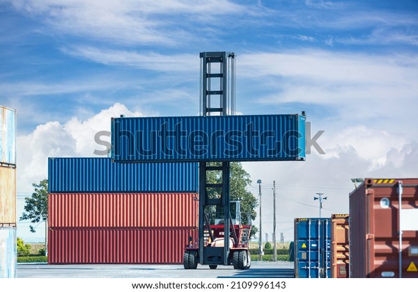 Crane\
lifting up container in railroad yard. Crane lifting up container\
in yard. forklift handling container box\
loading.	