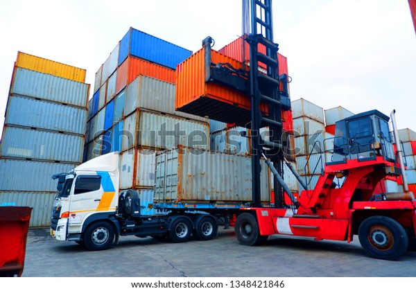 Crane lifting\
container truck loaded on\
truck