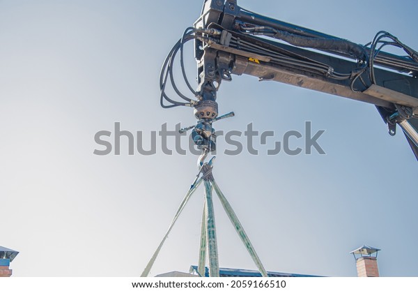 Crane lifts materials on the roof for\
construction and decoration of\
building.