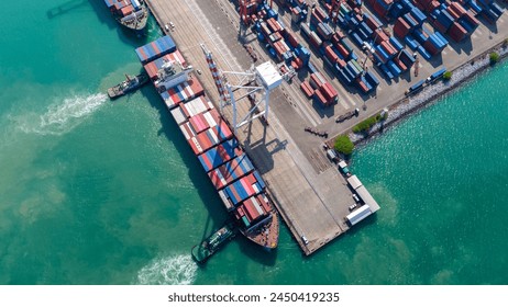 Crane loading box container to cargo ship at commercial dock port. Shipyard Cargo Container Sea Port Freight forwarding service logistics and transportation. International Shipping Depot Customs Port.