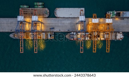 Crane loading box container to cargo ship at commercial dock port. Shipyard Cargo Container Sea Port Freight forwarding service logistics and transportation. International Shipping Depot Customs Port