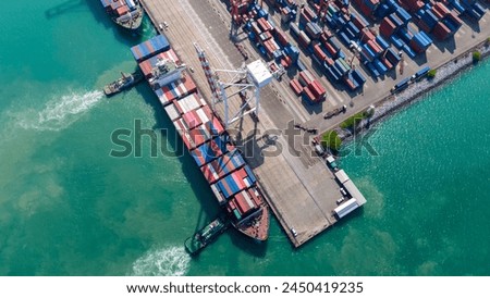 Crane loading box container to cargo ship at commercial dock port. Shipyard Cargo Container Sea Port Freight forwarding service logistics and transportation. International Shipping Depot Customs Port.