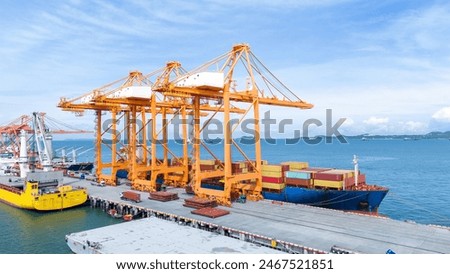 Crane loading box container to cargo ship at commercial dock port. Shipyard Cargo Container Sea Port Freight forwarding service logistics and transportation. International Shipping  Customs Port.	
