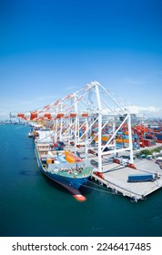 Crane loading cargo box to Large container Ship at Cargo Sea Port. Freight shipping container box transportation and logistics to Customs sea port.