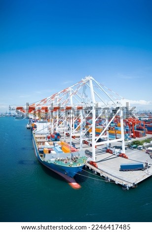 Crane loading cargo box to Large container Ship at Cargo Sea Port. Freight shipping container box transportation and logistics to Customs sea port.