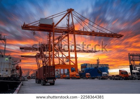 Crane loading cargo container freight container ship in the international terminal logistics sea port concept freight shipping by ship, Truck running in port under the Big Crane transport.