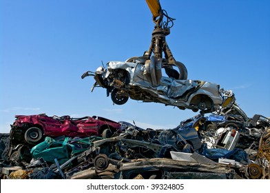 Crane Picking Up A Car In A Junkyard