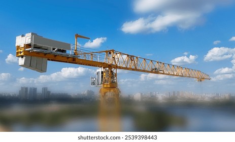 A crane is seen in the sky above a city. The crane is tall and has a yellow and white color scheme. The sky is clear and blue, and the city below is bustling with activity - Powered by Shutterstock