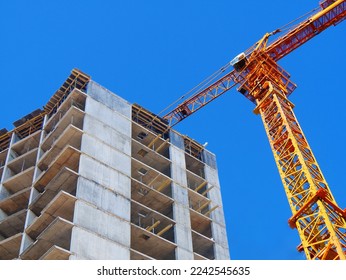 Crane. Self-erection crane over construction site. Crane near bulding. Industrial background.