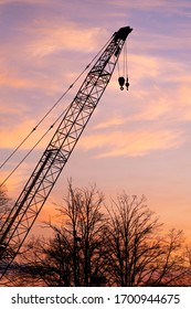 Crane Silhouette Against Sunset Over The Saginaw River.