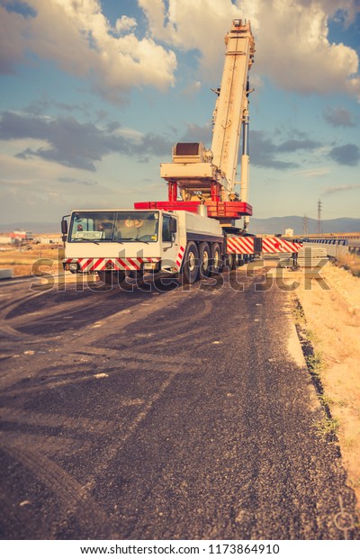 Crane\
truck in the construction of a bridge on a\
highway