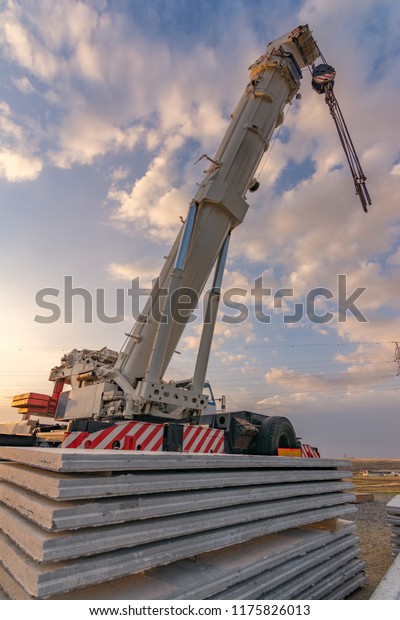 Crane\
truck in the construction of a bridge on a\
highway