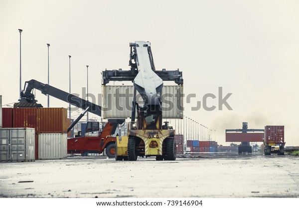 crane truck lift\
container in warehouse .