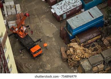 Crane Truck And Styled Crane Operator With Orange Umbrella.  