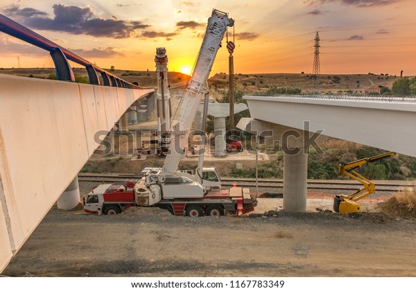 Crane trucks in\
the construction of a\
bridge