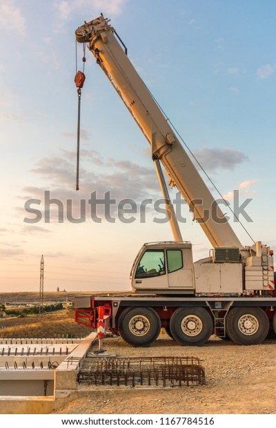 Crane trucks in\
the construction of a\
bridge