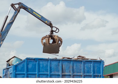 Crane-loading scrap grabber old metal at industrial metal recycling plant. Industrial metal waste recycling - Powered by Shutterstock