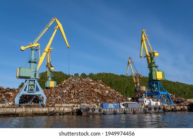Cranes loading scrap metal In port