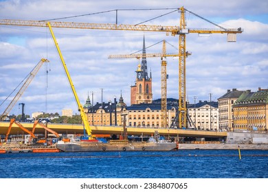 Cranes at Stockholm city Gamla Stan island construction site view, development of capital of Sweden
