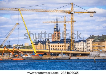 Cranes at Stockholm city Gamla Stan island construction site view, development of capital of Sweden