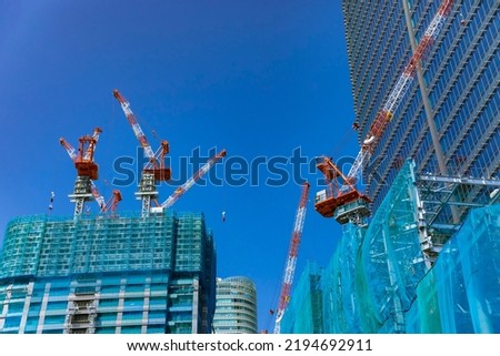 Cranes at the under construction daytime. High quality photo. Minato district Iikurakatamachi Tokyo Japan 08.09.2022 It is center of the city in Tokyo.