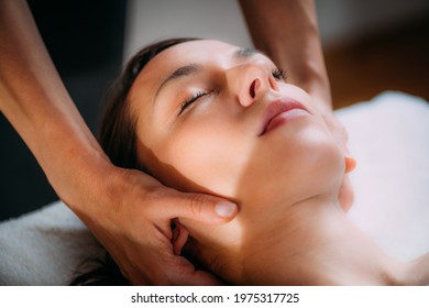 Cranial osteopathy massage. Therapist massaging woman’s head.