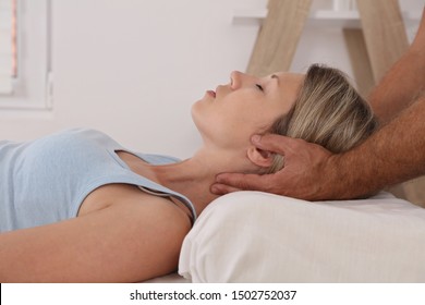 Craniosacral therapy. Back and Neck pain , Osteopathy treatment. Physiotherapy for female patient. Kinesiology practitioner