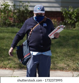 CRANSTON, RHODE ISLAND/USA- MAY 13, 2020: Mail Carrier, Richard Sowden, Of The USPS Delivers Mail During The Coronavirus Pandemic                               