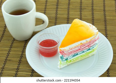 Crape cake with hot tea on bamboo mat - Shutterstock ID 221194354