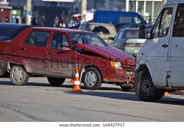 Crash broken car and orange road hazard cone on\
accident site