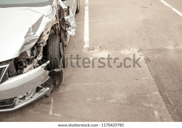 Crash car in front\
after the accident. Broken wing and wheel, bumper and\
undercarriage. Copy space for\
text