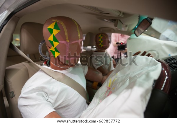 Crash Test\
Dummies in a car after a Crash\
Test.