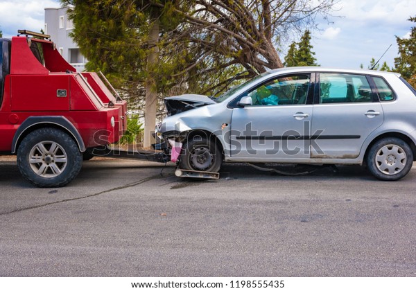 Crashed car after accident ready to be tow away by\
tow truck