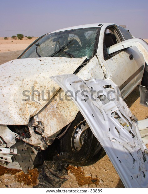 A crashed car in Arabia. Extensively damaged in a\
high-speed loss of control