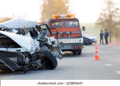 Crashed Car Automobile Collision Accident With Police And Tow Truck At Road