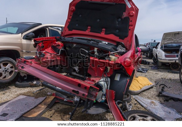 Crashed car in junk yard\
without engine