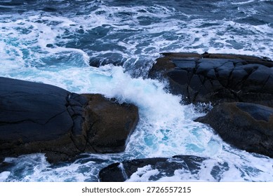 Crashing Waves Exploding Against Rugged Black Rocks in Turquoise Fury