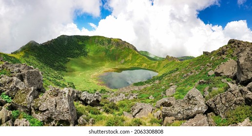 It is a crater of Hallasan Mountain in Jeju Island, South Korea, and its name is Baenglokdam.
The harmony between the blue sky, white clouds and green leaves and the pond is beautiful. - Powered by Shutterstock