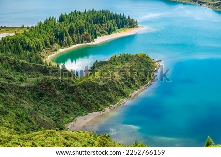 Crater hill with vegetation and cryptomerias and turquoise blue water of Lagoa do Fogo, São Miguel - Azores PORTUGAL
