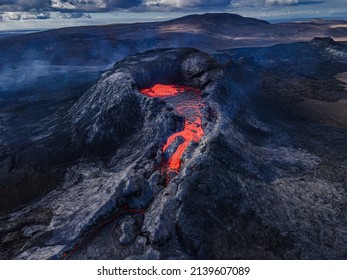 Crater Opening From Fagradalsfjall Volcano. View From Above Into The Volcanic Crater With Strong Lava Flow On Iceland In The GeoPark. Daytime Volcanic Eruption On Reykjanes Peninsula