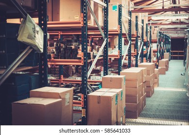 Crates and boxes on a shelves in a warehouse - Shutterstock ID 585641033