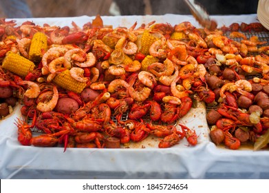 Crawfish Boils. Louisiana, New Orleans Crawfish Boil. Crawfish, Shrimp, Lobster, Seafood, Corn On The Cob, Sausage, Potatoes Boiled In Cajun Seasonings And Herbs. Classic Cajun Or Creole Cuisine.