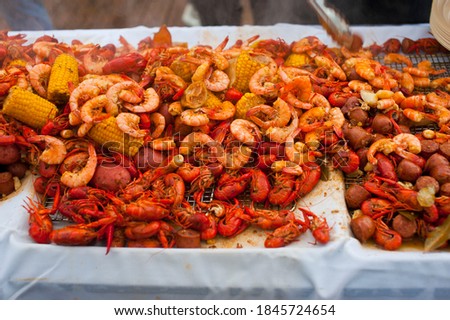 Crawfish boils. Louisiana, New Orleans Crawfish Boil. Crawfish, shrimp, lobster, seafood, corn on the cob, sausage, potatoes boiled in Cajun seasonings and herbs. Classic Cajun or Creole cuisine.