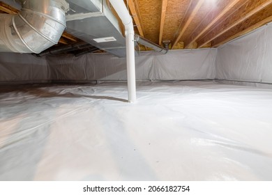 Crawl space fully encapsulated with thermoregulatory blankets and dimple board. Radon mitigation system pipes visible. Basement location for energy saving home improvement concept. - Shutterstock ID 2066182754