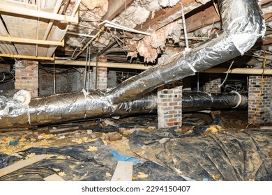 Crawl Space under house with air conditioner ductwork and insulation - Shutterstock ID 2294150407